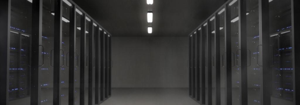 supercomputer nodes racks arranged in rows on a building floor
